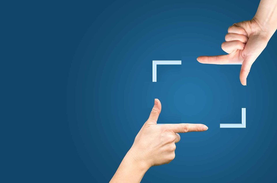 Female hands showing cropping composition gesture. Isolated on blue.|different video equipment view from above