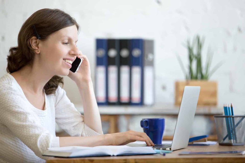 Discovery Call: An Essential Tool For The Future|young woman holding mobile phone in office