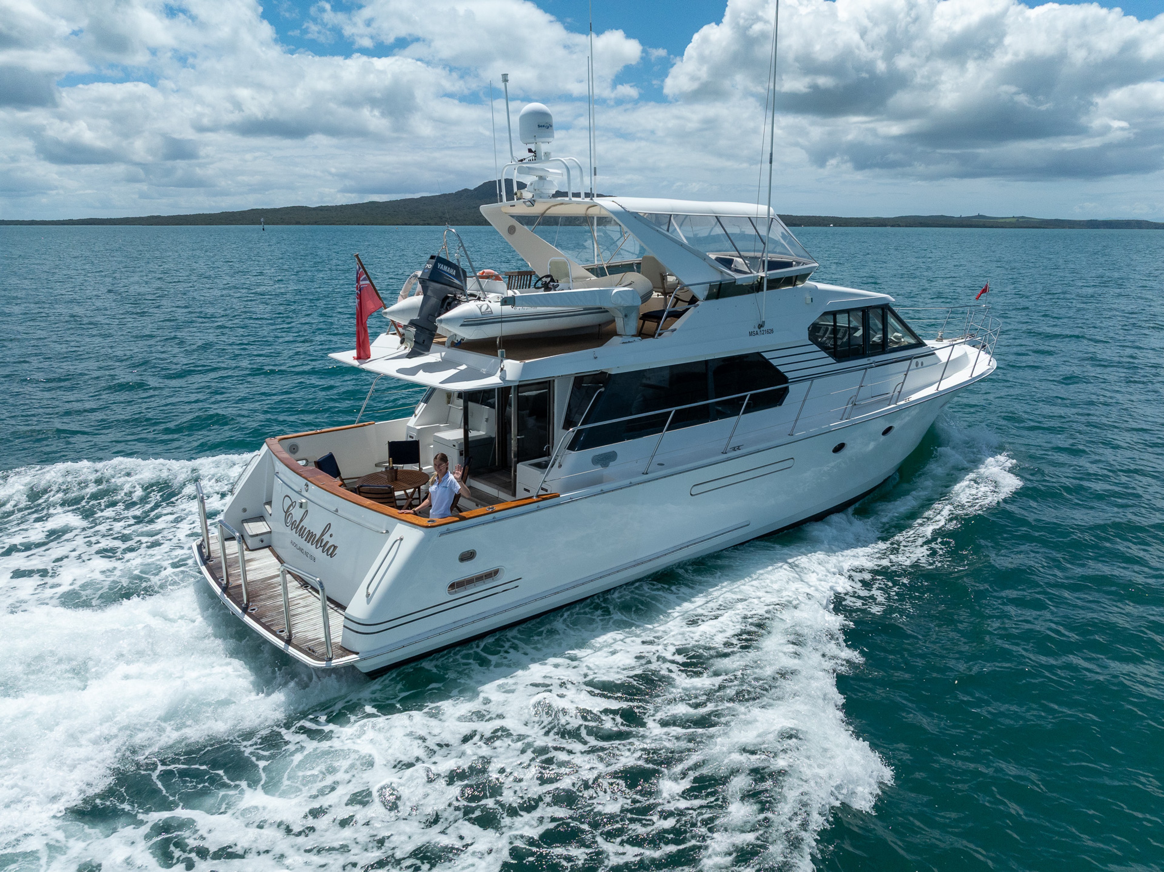 Boat with human standing  at the back cabin
