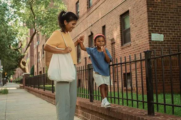 Woman and child walking in a city