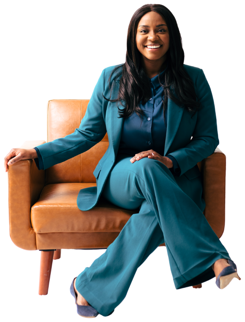 Danielle Bayard Jackson in a teal suit, seated in a leather armchair