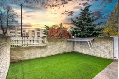 Clear back garden with astroturf, and a beautiful sunset