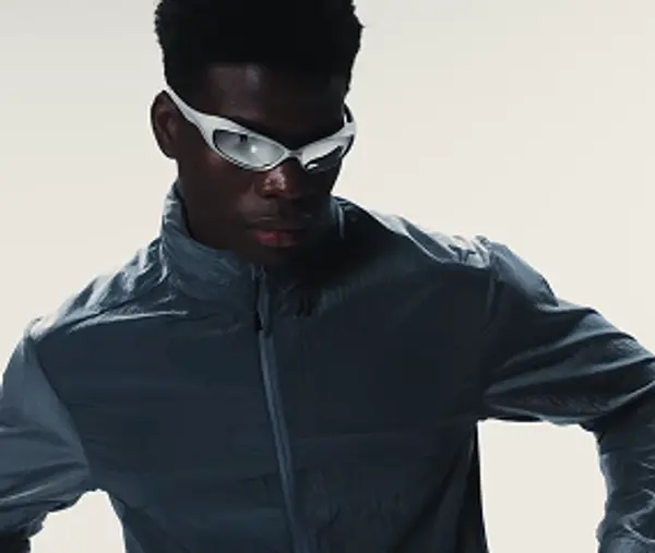 Dramatic black and white portrait of a male athlete wearing sunglasses