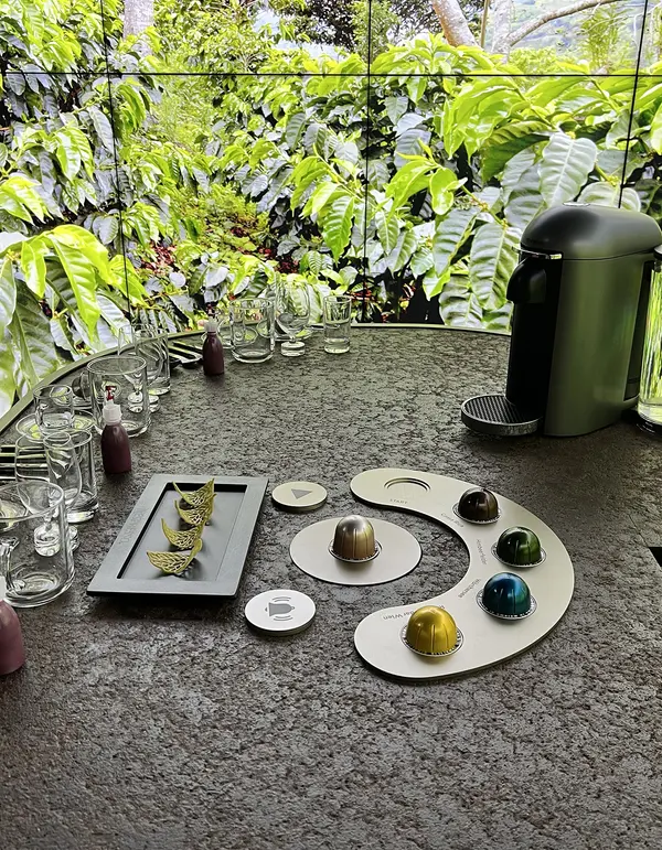 Close-up of a restaurant coffee setup featuring a Nespresso machine and coffee pods