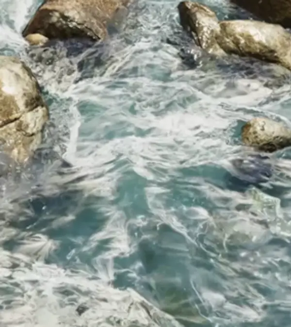 3D water simulation showing water flowing through a rocky river environment