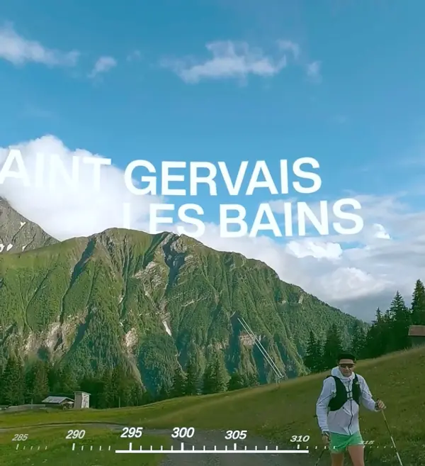 VR headset view of a hiker walking through a grassy mountain field with digital mountain labels