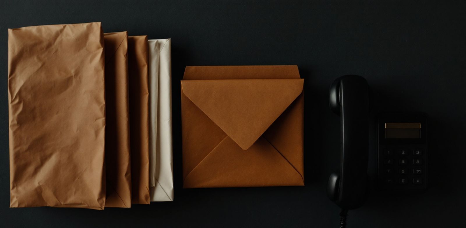 Sealed envelopes, a dark phone, and a brass lock representing cautious outbound.