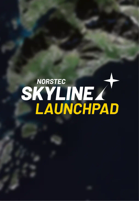 Satellite view of a coastal region with green mountains, rocky islands, and deep blue ocean.