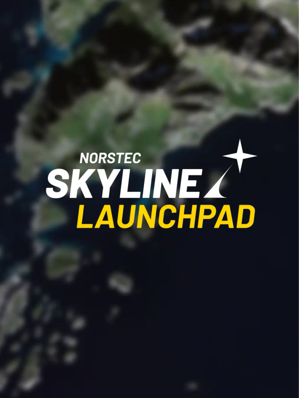 Satellite view of a coastal region with green mountains, rocky islands, and deep blue ocean.