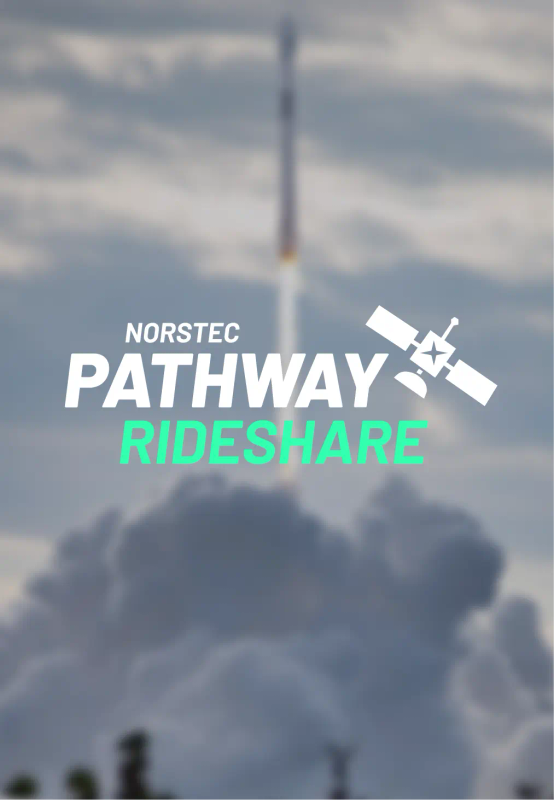 Rocket launching upward through thick clouds, leaving a bright plume against a partly cloudy sky.