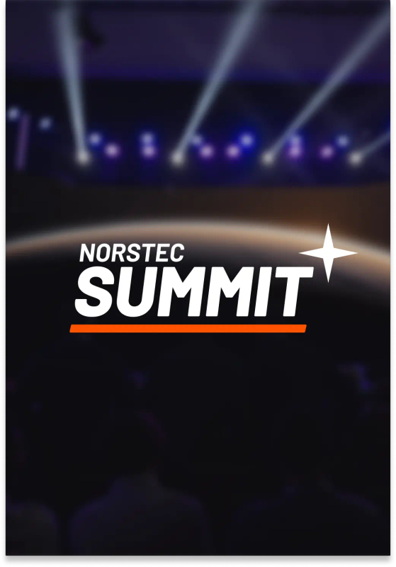 Audience watching a large stage with a screen showing the NORSTEC logo over a planet backdrop, with purple and blue stage lights overhead.