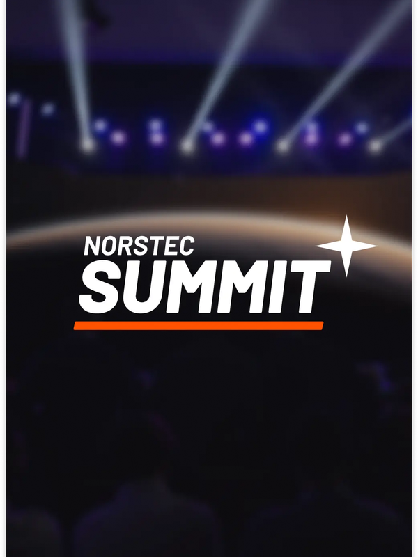 Audience watching a large stage with a screen showing the NORSTEC logo over a planet backdrop, with purple and blue stage lights overhead.