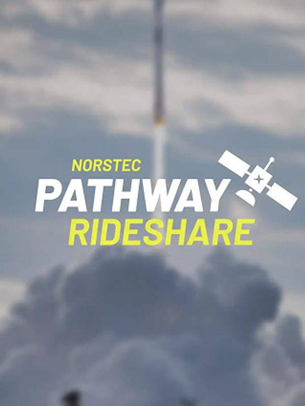 Rocket launching upward through thick clouds, leaving a bright plume against a partly cloudy sky.