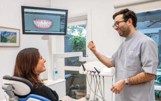 Image of a dentist talking about his patient's dental options.