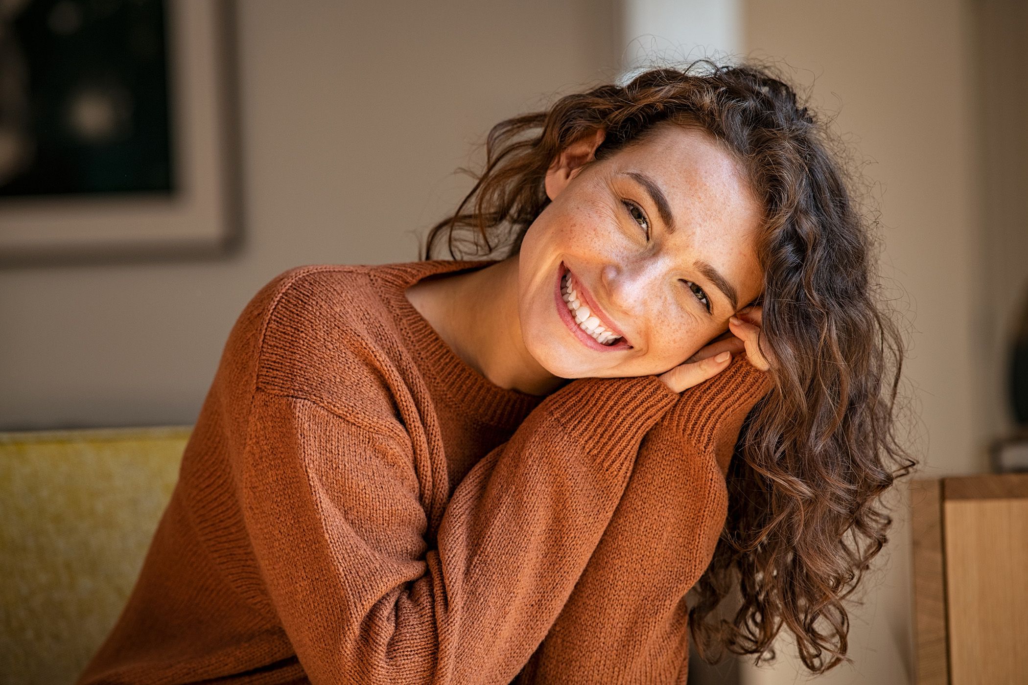 Image of a lady in the sun with a big white smile on her face.