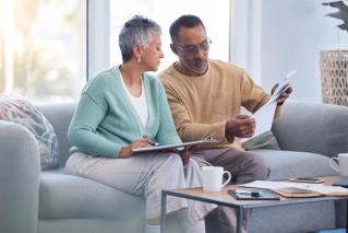 Image of a couple discussing dental treatments with each other at their home.