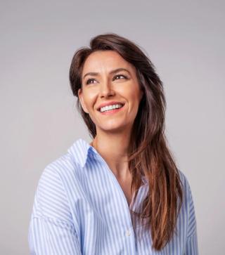 Stock image of female posing showing her white teeth.