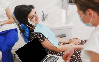 Female patient and dentist using a neuromuscular stimulator