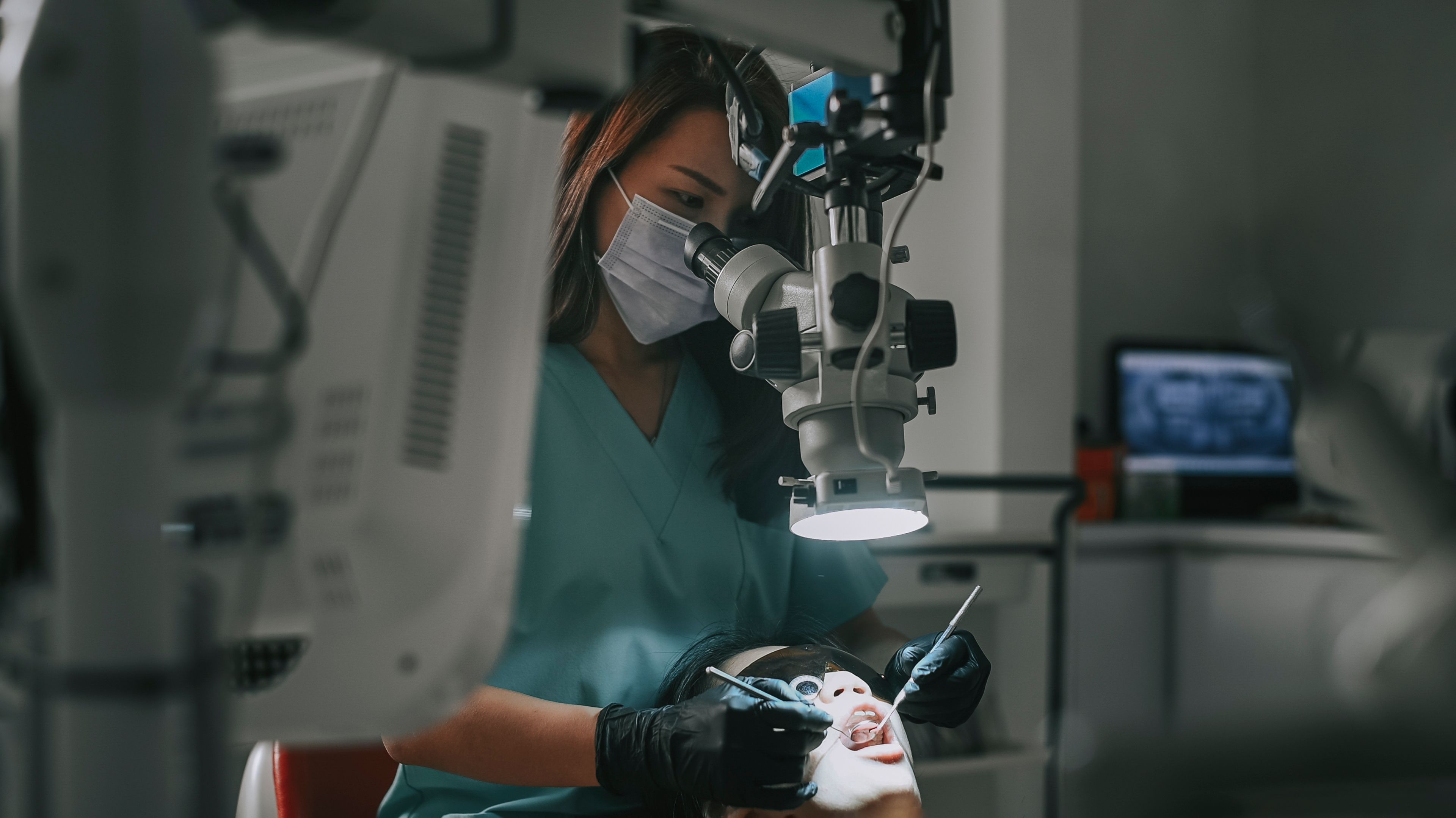 Dentist using high-tech dental equipment to inspect patients mouth