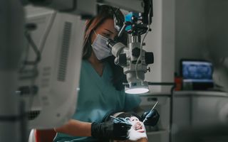 Endodontist treating a patient under a microscope