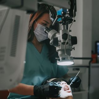 Dentist using high-tech dental equipment to inspect patients mouth