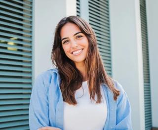 Happy couple on the beach with their white teeth