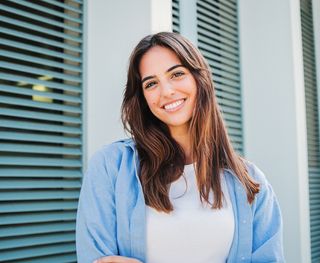 Image of a young female, with a nice smile. At Richmond Fine Dentistry, your dental health is our priority.