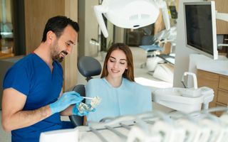 Dentist walking patient through a dental bridge treatment