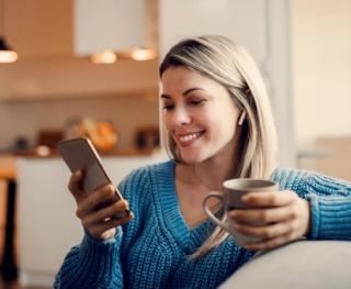 Female enjoying with white teeth at home