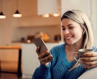 Female enjoying with white teeth at home