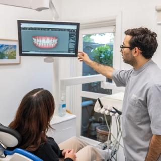 A patient going over their dental x-rays with their dentist.