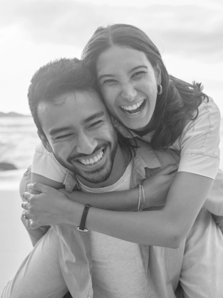 A black and white image of a smiling couple