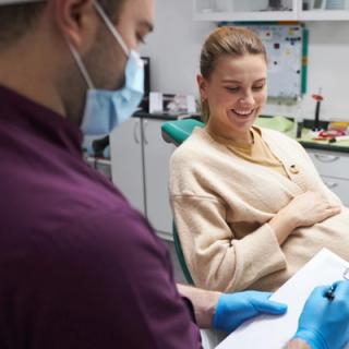 Image of a pregnant patient discussing a dental procedure.