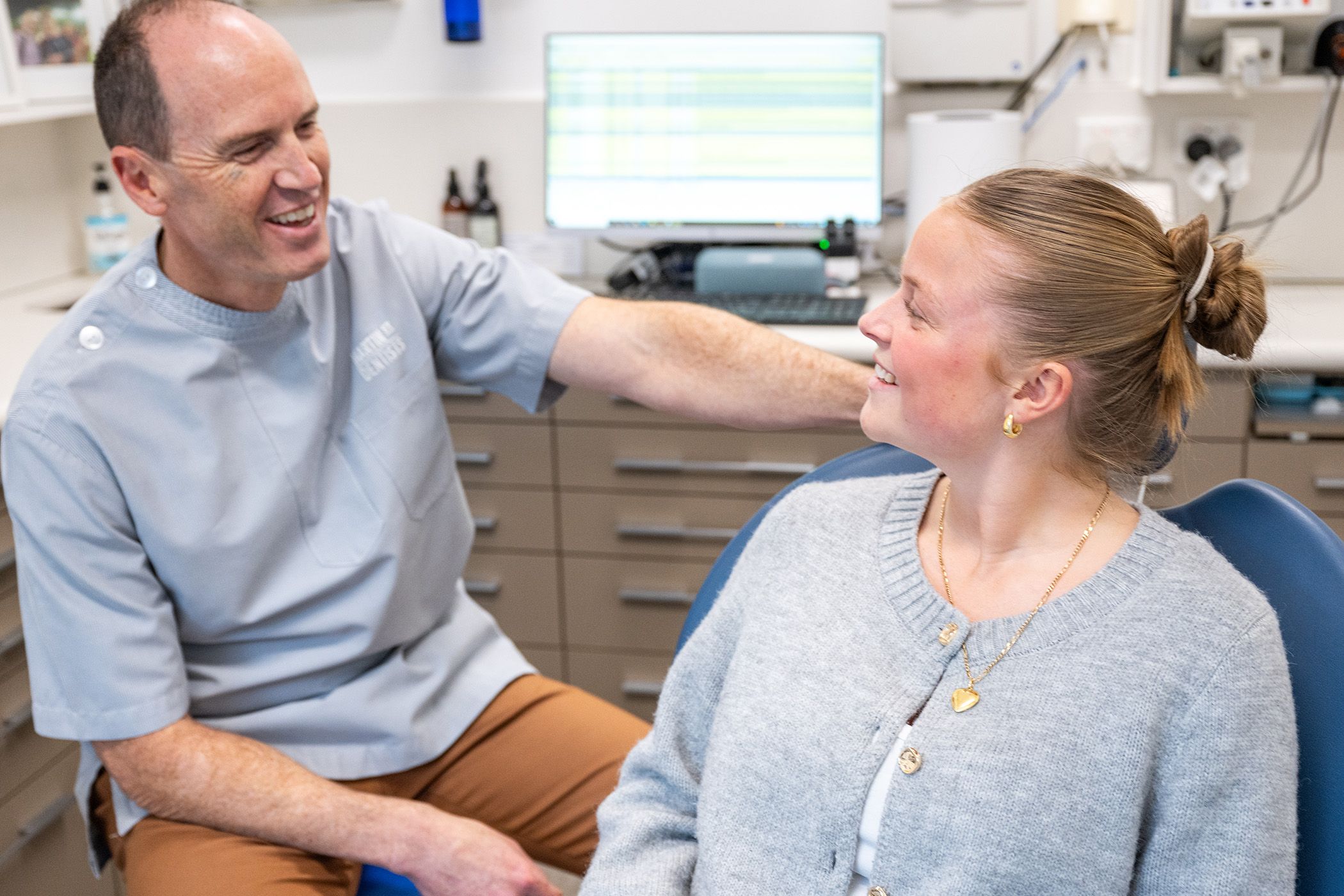 Patient dicsussing dental treatment with a dentist