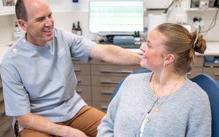 Patient dicsussing dental treatment with a dentist