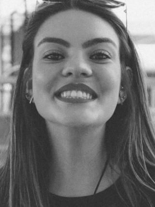 A black and white image of a smiling woman
