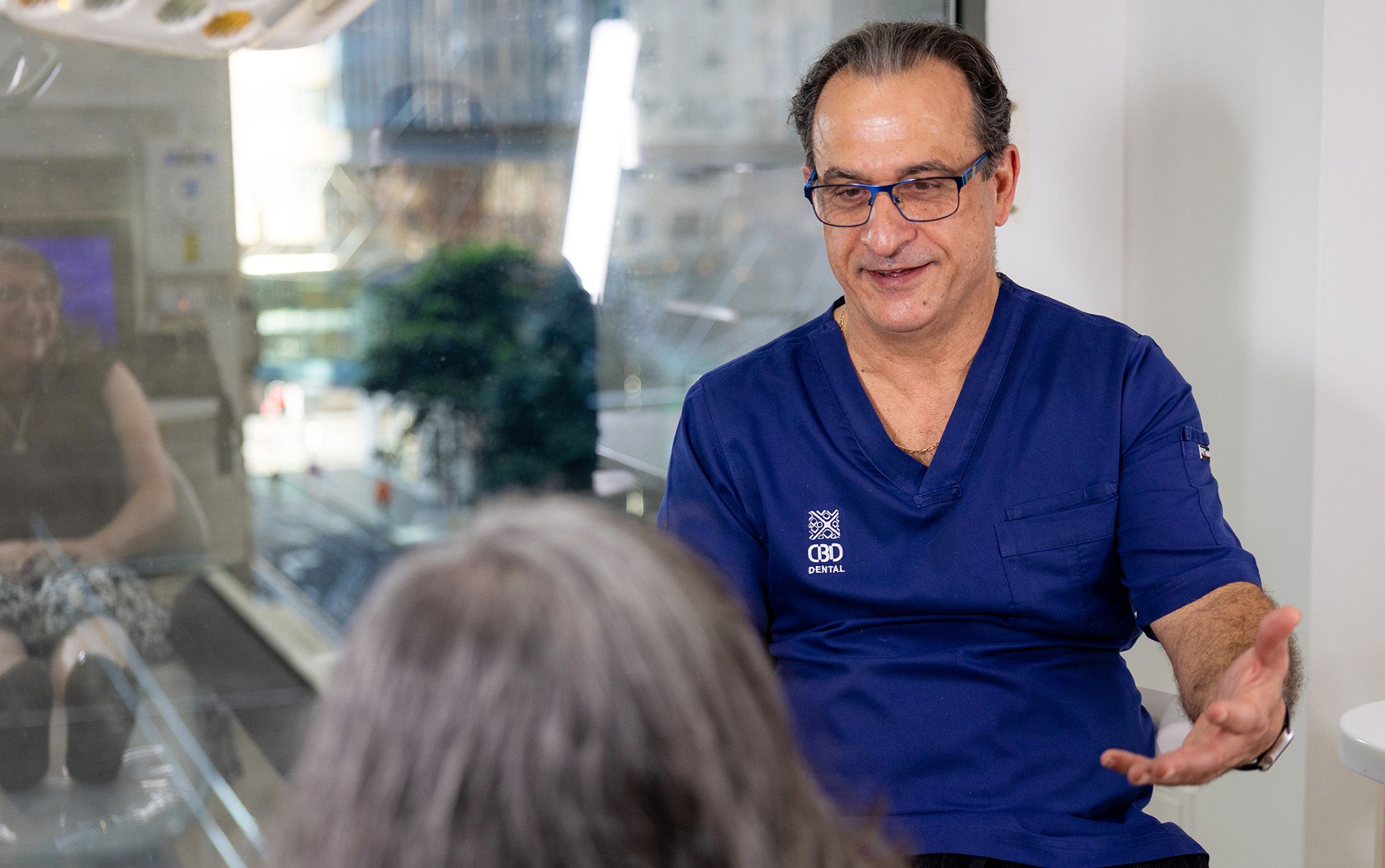 Image of our dentist consulting with his patient in Sydney CBD.