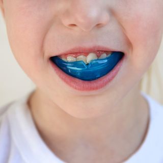 Image of a man looking at his teeth with happiness.