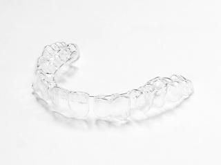 Custom made by a dentist or dental professional