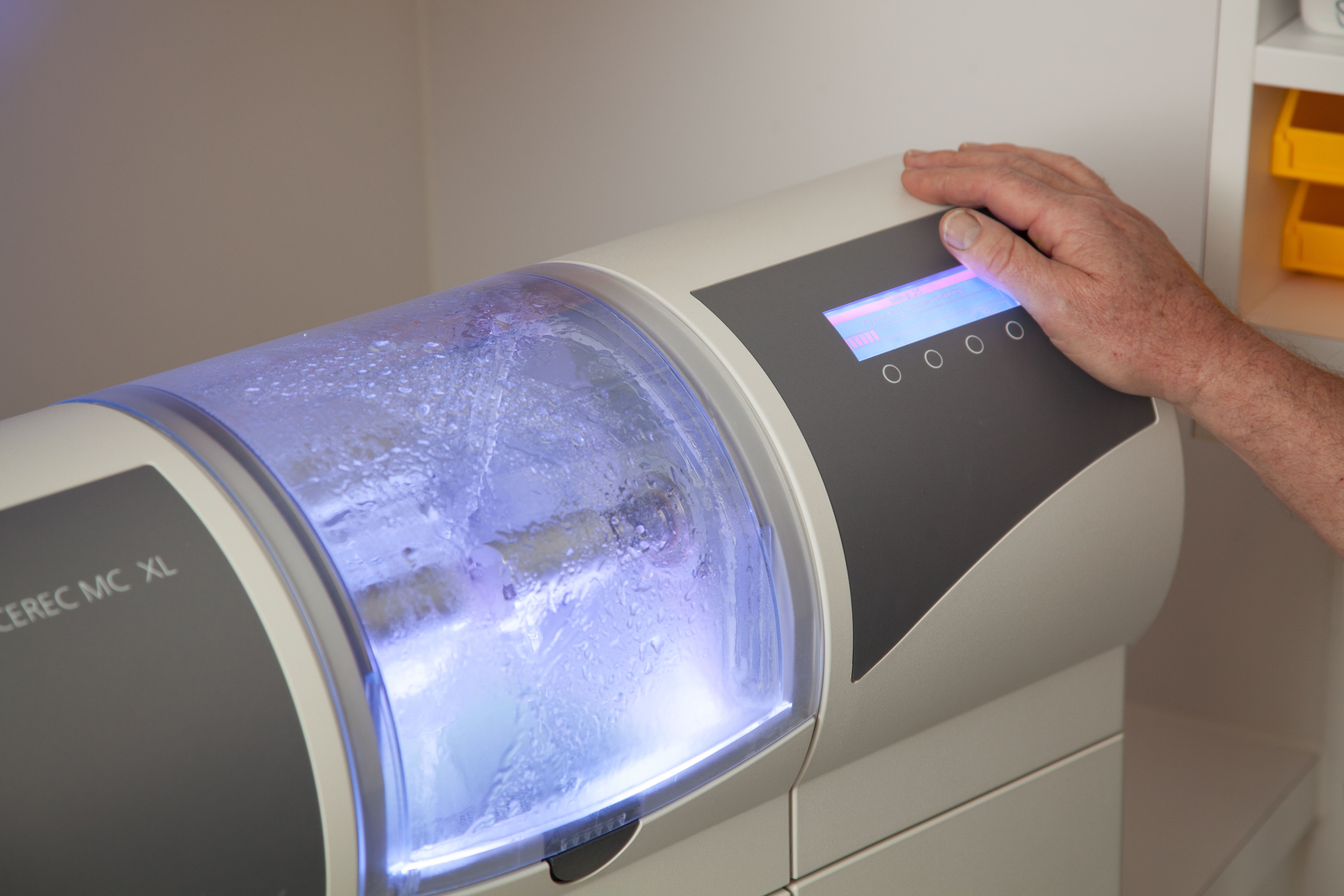 Dentist using CEREC to scan the mouth of a patient