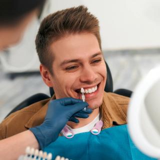 Image of a male picking the correct shade of white for his teeth.