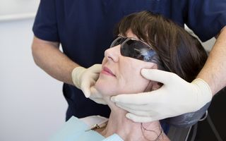 Dentist examining a patients mouth