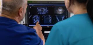 Image of a 3D dental scan of a patient's teeth being reviewed by our dental team.