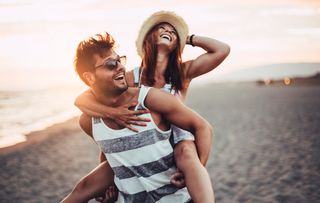 Happy couple exploring Australian beach