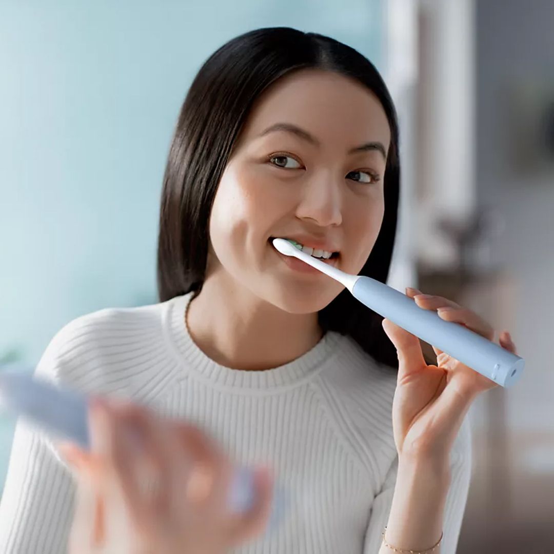 A female patient using her new sonic toothbrush