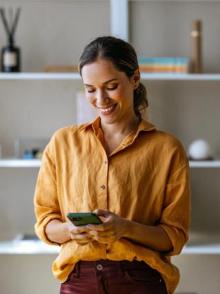 Image of a female on her phone booking an appointment to our dental appointment.