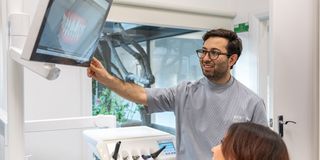 Image of Dr Adam Sibio with his patient in his dental space.