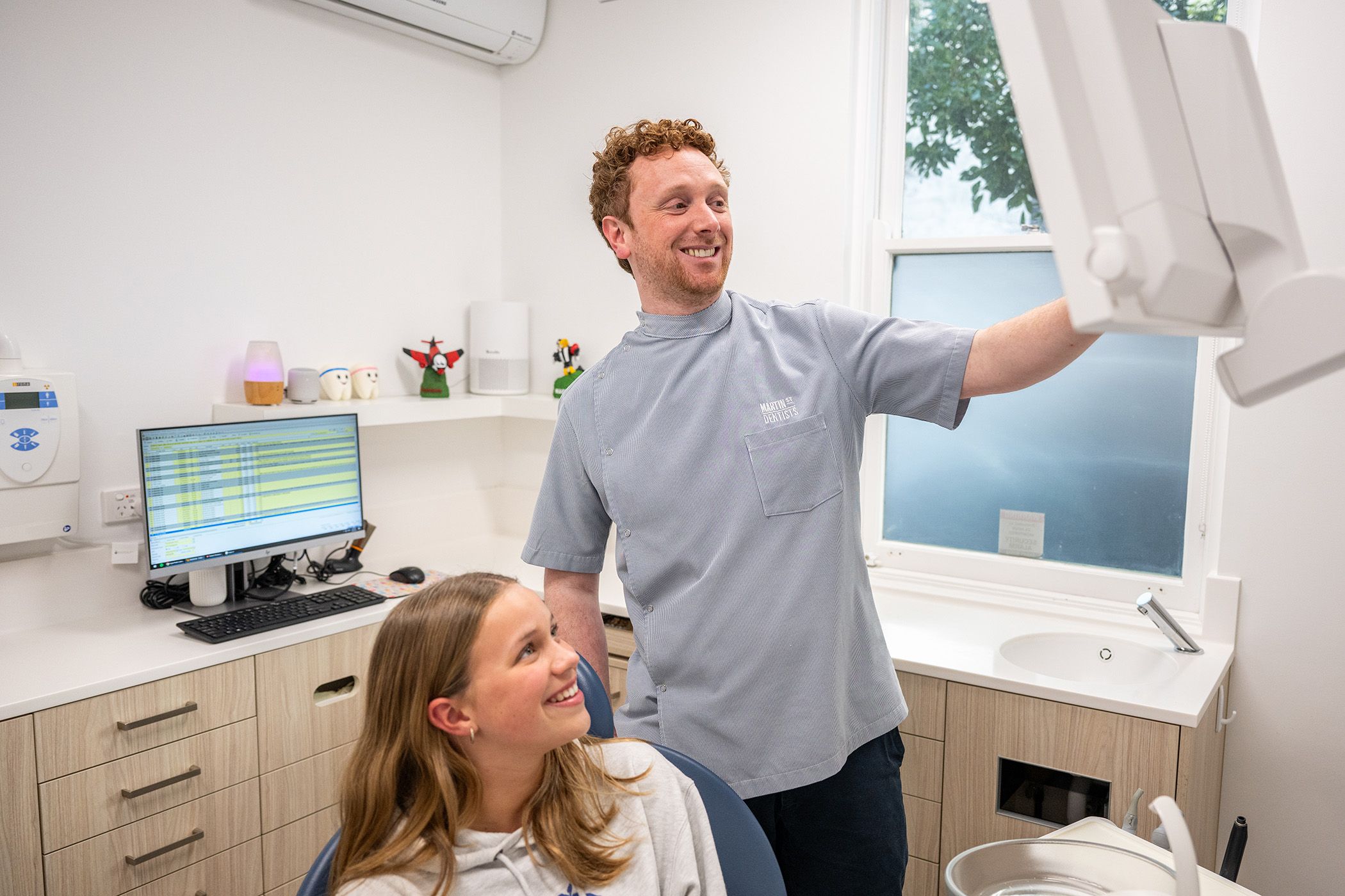 Image of Dr Brett Borger with his patient in his dental space.