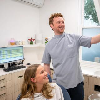 Image of a child practicing how to brush his teeth for good dental habits.