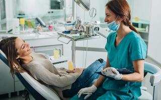 Dentist talking with patient during treatment